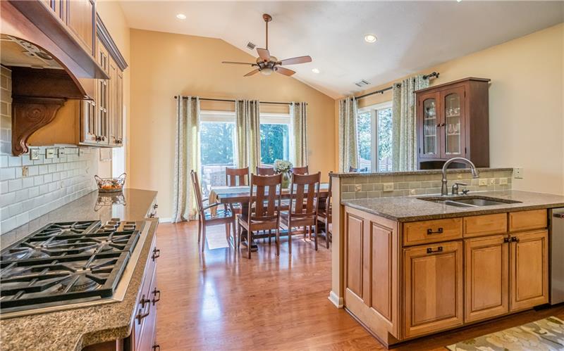 231 Brown Road Wexford, PA 15090 - Photo 8 of 25 Large open kitchen with upgraded appliances. 5 Burners to cook many gourmet meals. Granite Counters. Subway tile backsplash. Vaulted ceiling for the dining area.