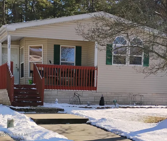 a view of a house with backyard porch and sitting area