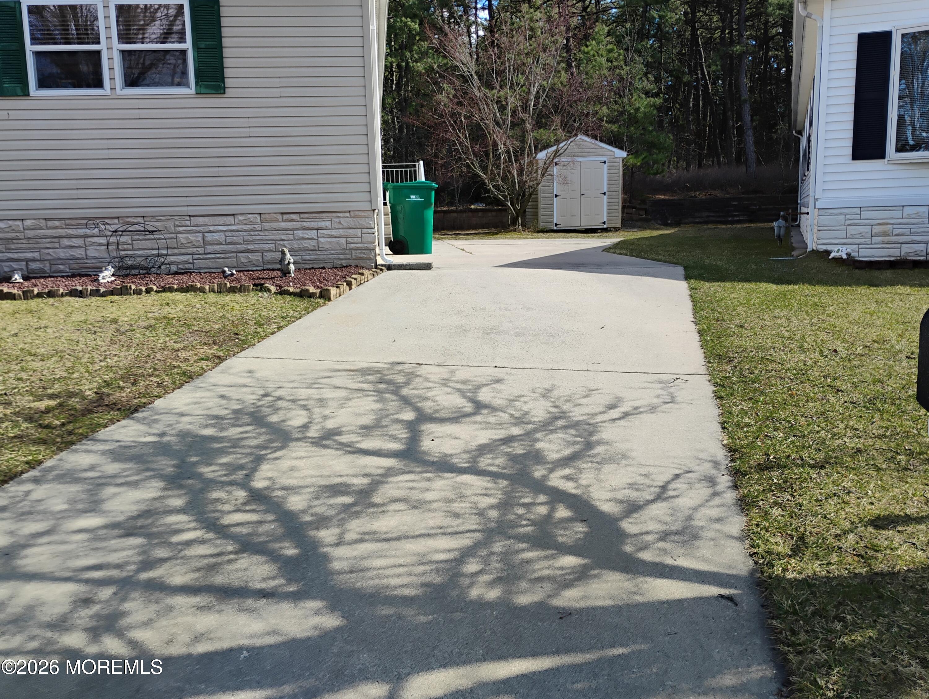 1208 Winding Brook Way Whiting, NJ 08759 - Photo 3 of 21 a front view of a house with a yard and garage