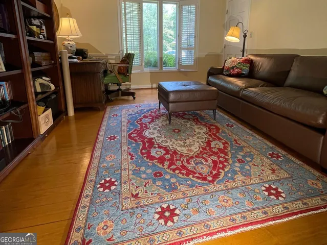 a living room with furniture and a floor to ceiling window