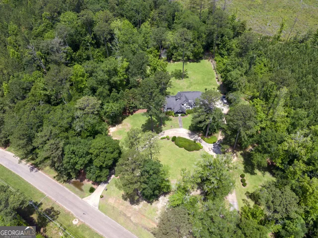 a view of a wooden house with a yard