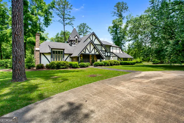 a view of house with yard and green space
