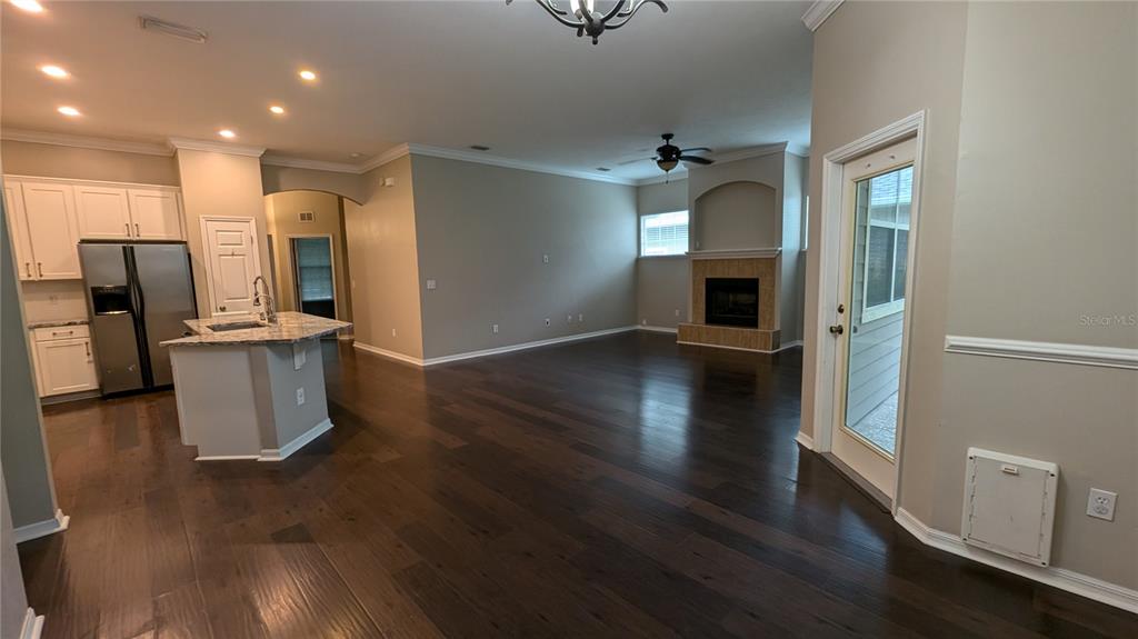 7401 Southwest 86th Way Gainesville, FL 32608 - Photo 5 of 12 a open kitchen with a refrigerator and a stove top oven
