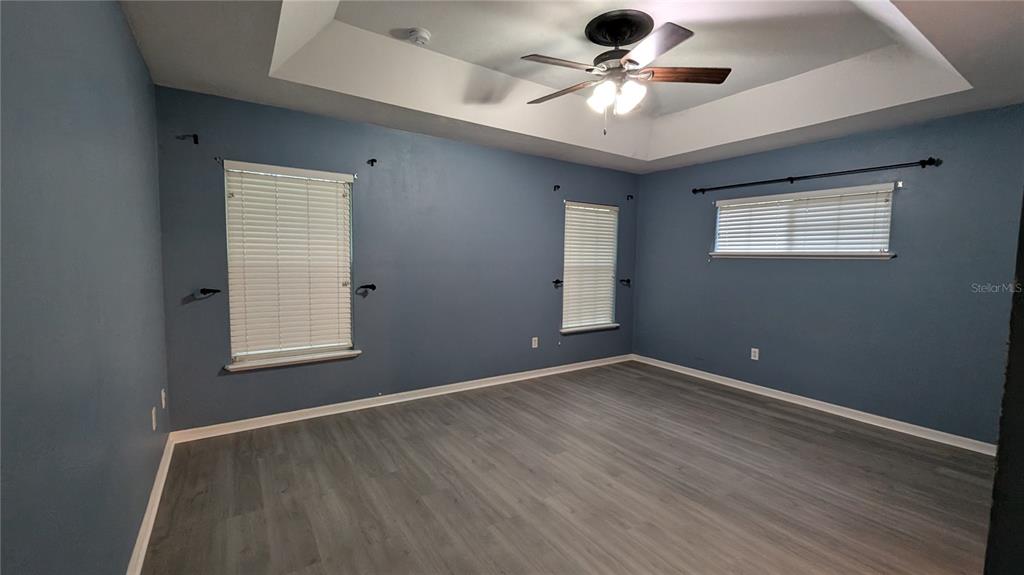 7401 Southwest 86th Way Gainesville, FL 32608 - Photo 6 of 12 an empty room with a window and a ceiling fan
