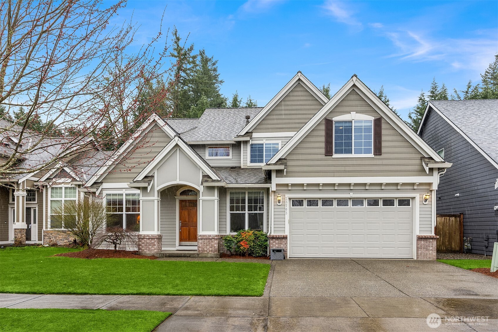 23703 Southeast 284th Street Maple Valley, WA 98038 - Photo 1 of 33 a front view of a house with a yard