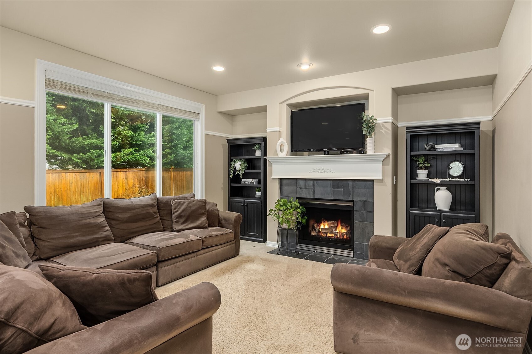 23703 Southeast 284th Street Maple Valley, WA 98038 - Photo 13 of 33 a living room with furniture or flat screen tv and a fireplace