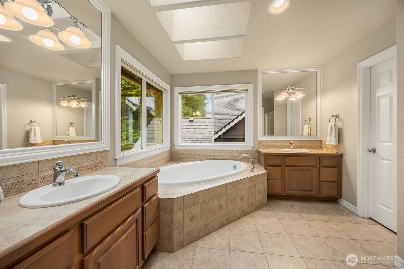 23703 Southeast 284th Street Maple Valley, WA 98038 - Photo 18 of 33 a bathroom with a granite countertop sink mirror bathtub and window