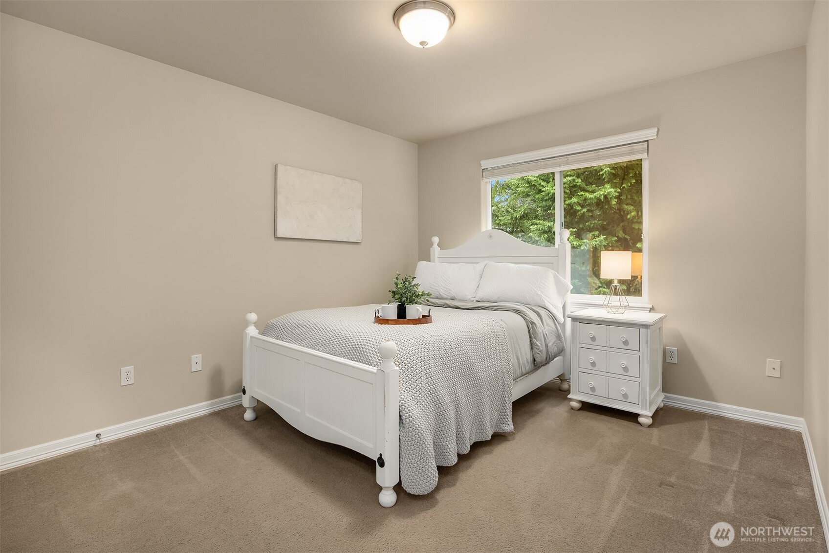 23703 Southeast 284th Street Maple Valley, WA 98038 - Photo 20 of 33 a bed sitting in a bedroom next to a window