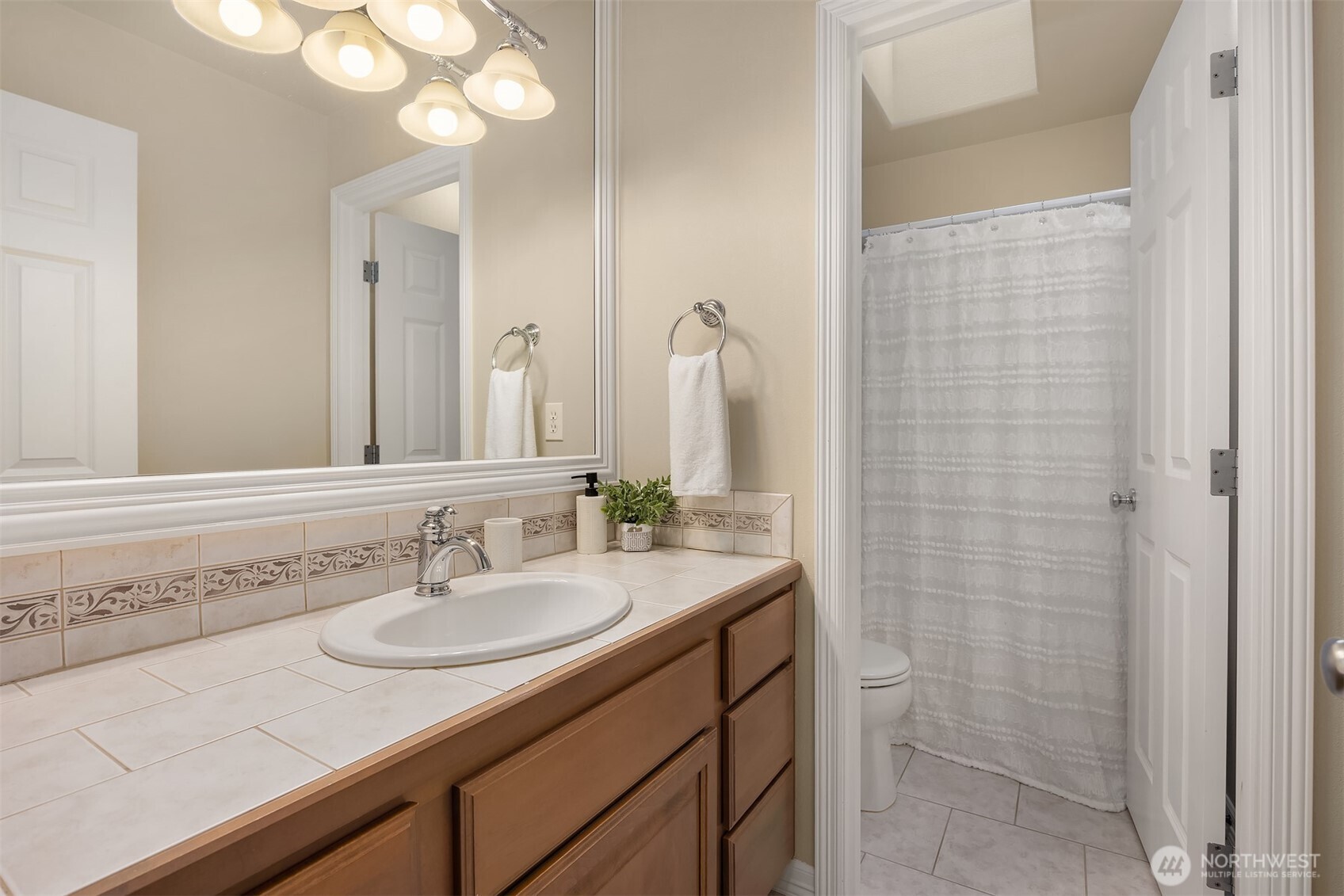 23703 Southeast 284th Street Maple Valley, WA 98038 - Photo 21 of 33 a bathroom with a sink and a mirror