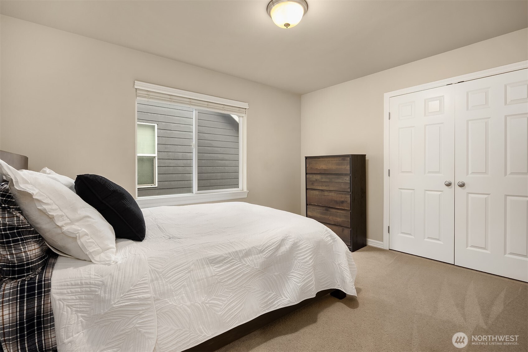23703 Southeast 284th Street Maple Valley, WA 98038 - Photo 22 of 33 a bedroom with a bed and wooden floor
