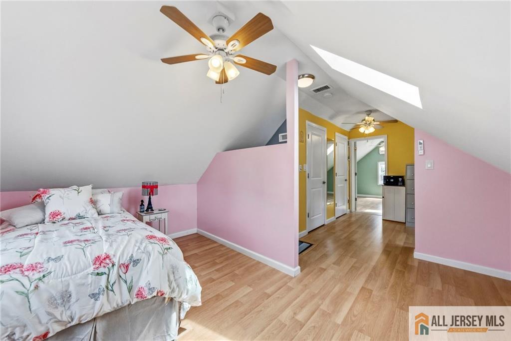 50 3rd Street Fords, NJ 08863 - Photo 19 of 36 a bedroom with a bed and a chandelier