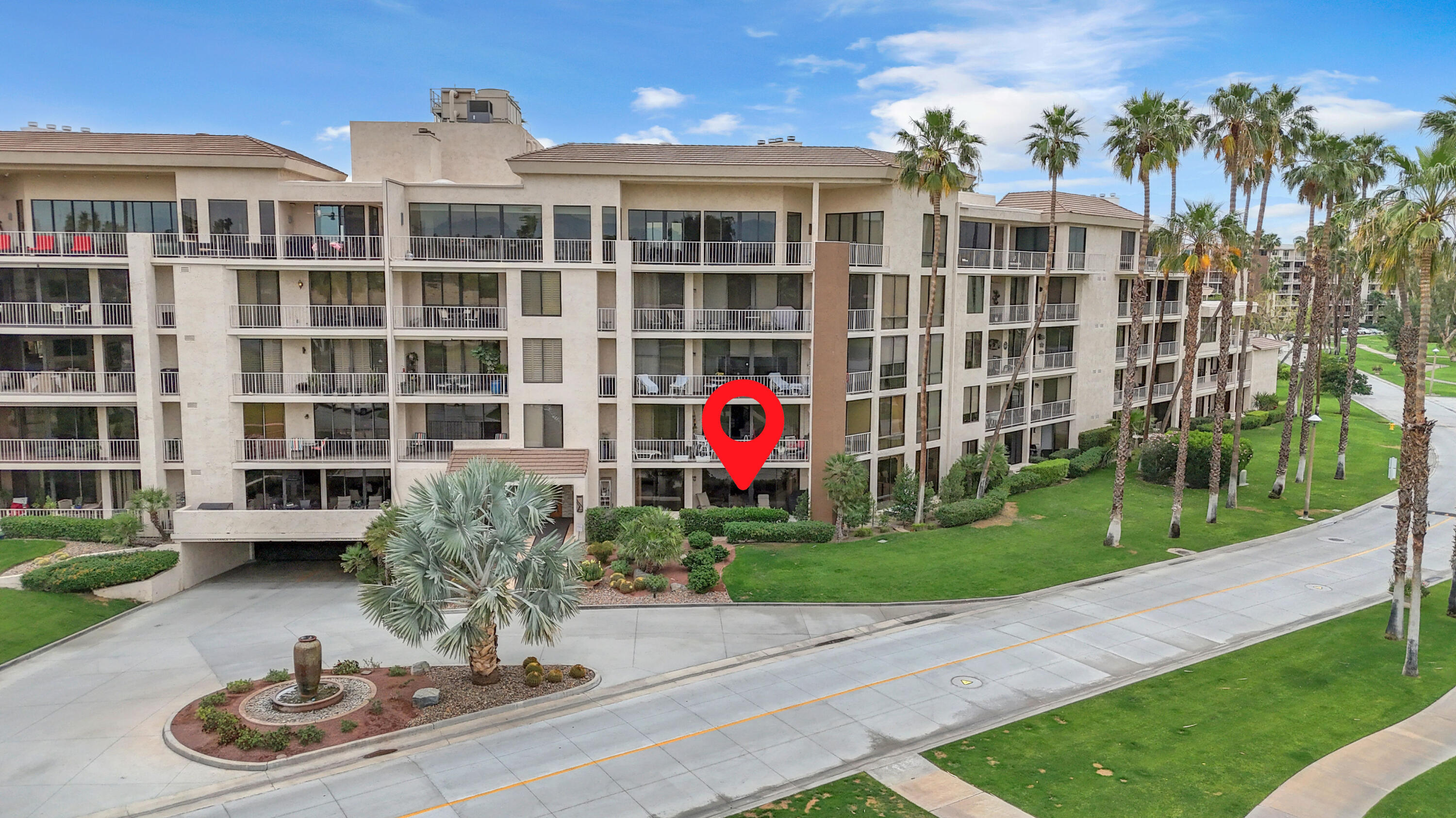 a aerial view of multi story residential apartment building with a yard and potted plants