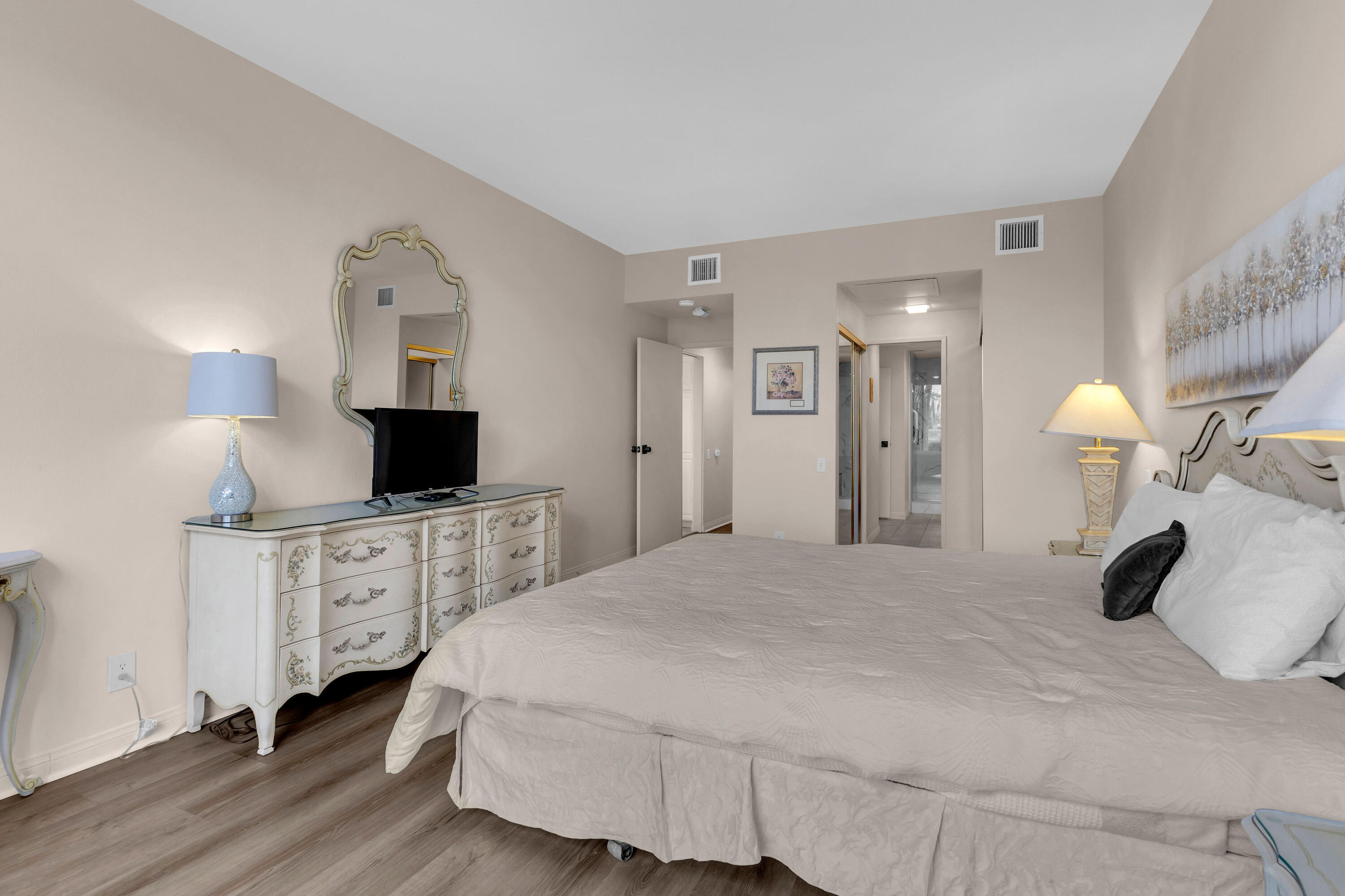 910 Island Drive, Unit 112 Rancho Mirage, CA 92270 - Photo 31 of 47 a bedroom with a bed and a flat screen tv