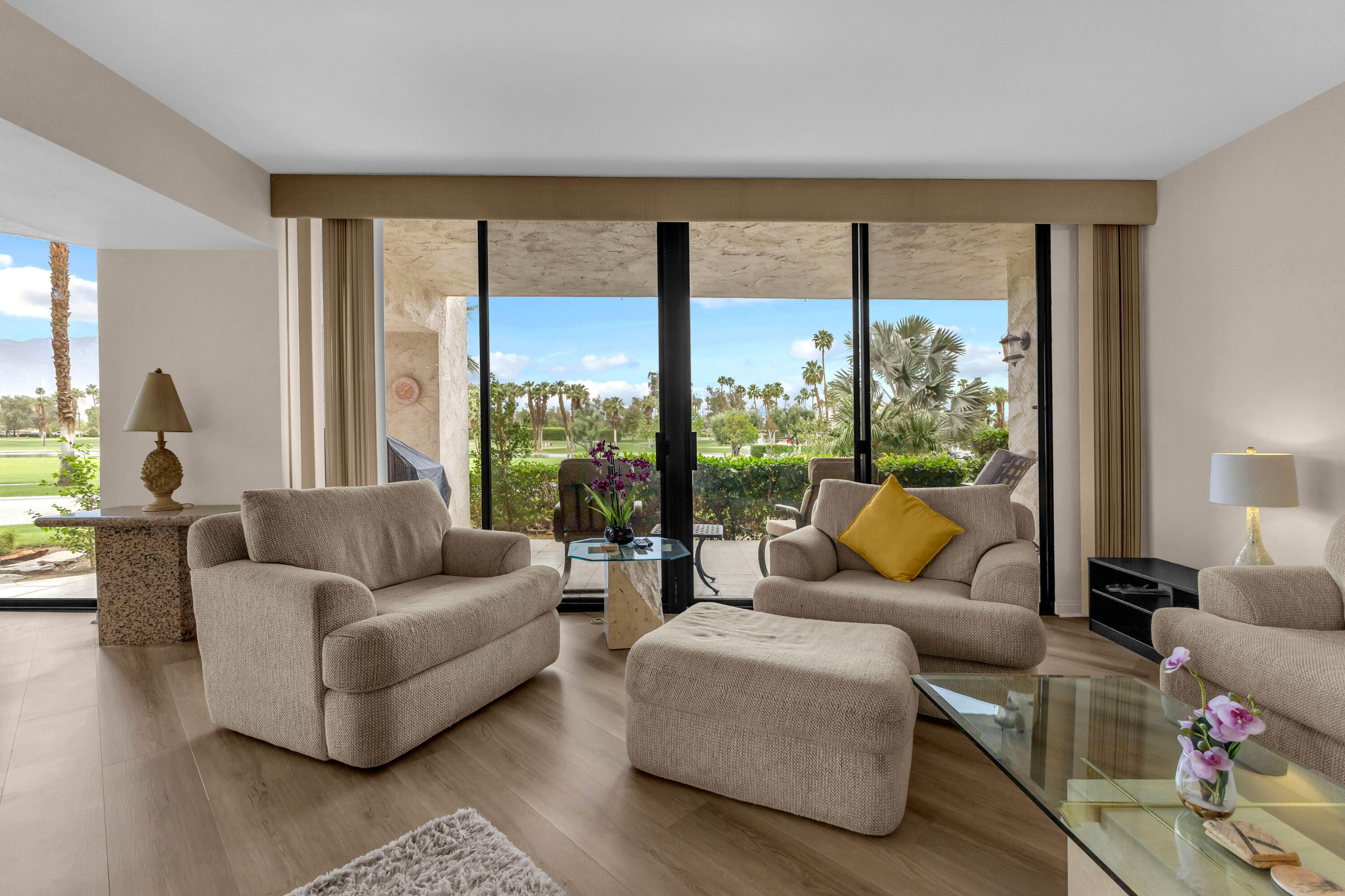 910 Island Drive, Unit 112 Rancho Mirage, CA 92270 - Photo 5 of 47 a living room with furniture and a large window