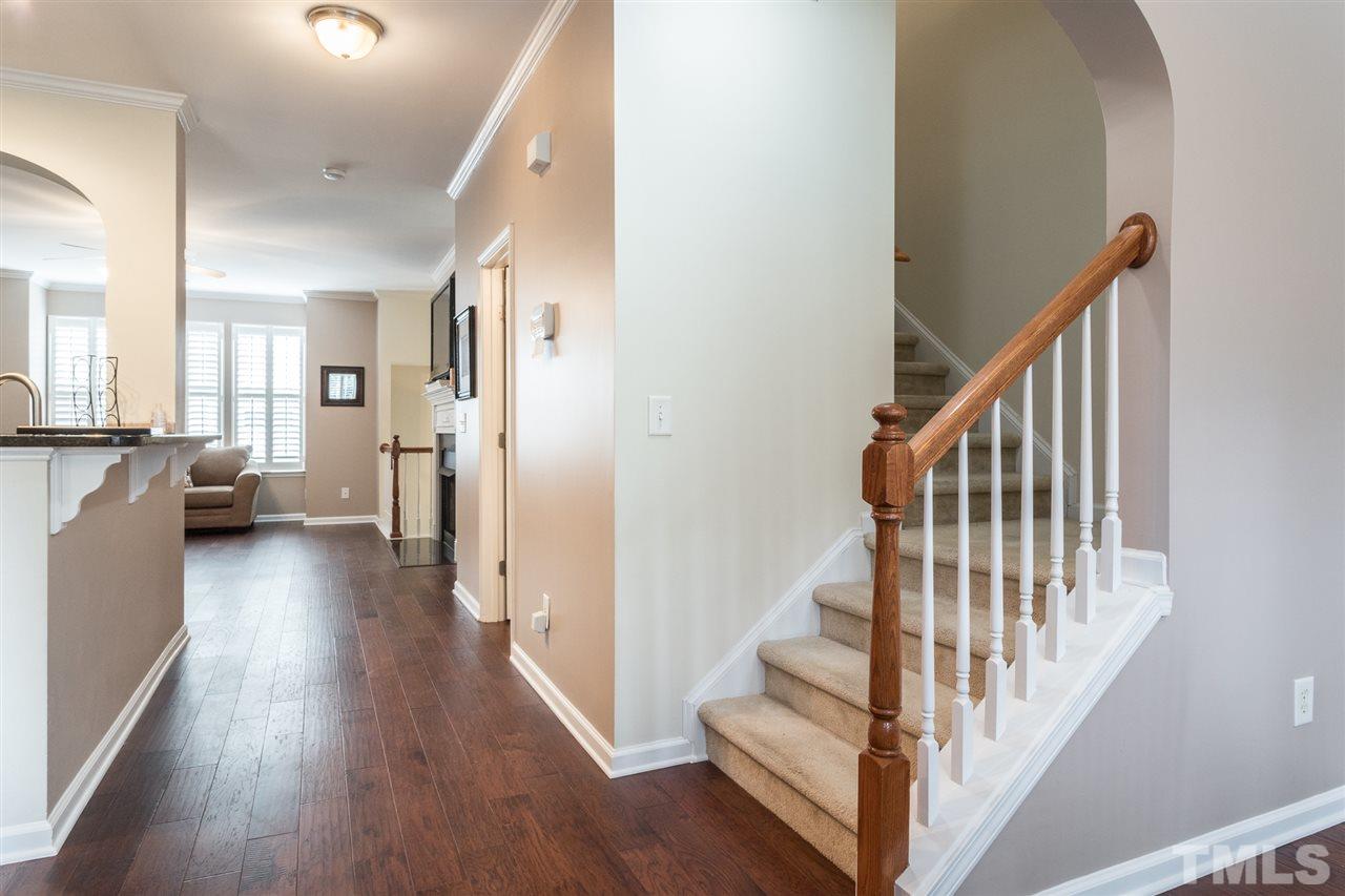 5004 Celtic Court Raleigh, NC 27612 - Photo 13 of 26 a view of a hallway with wooden floor and stairs