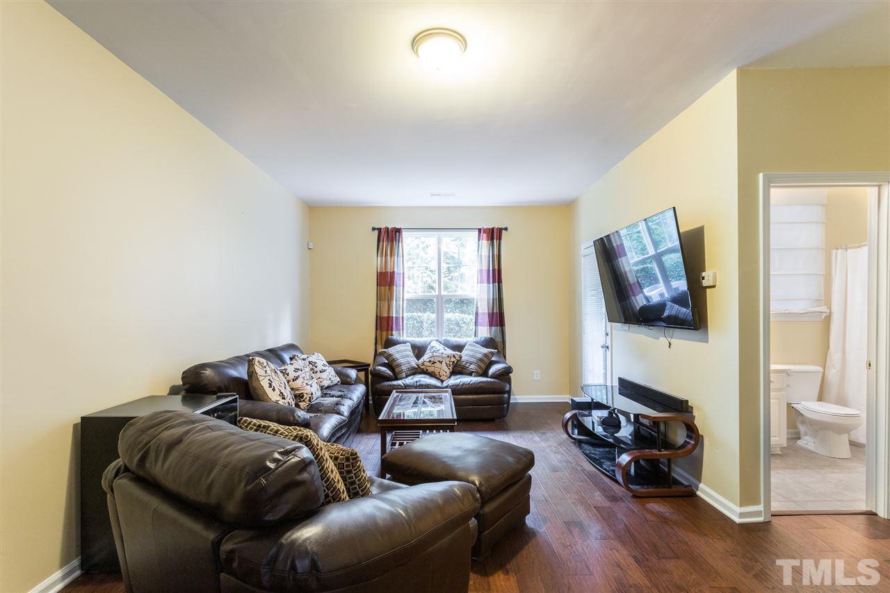 5004 Celtic Court Raleigh, NC 27612 - Photo 16 of 26 a living room with furniture window and a flat screen tv