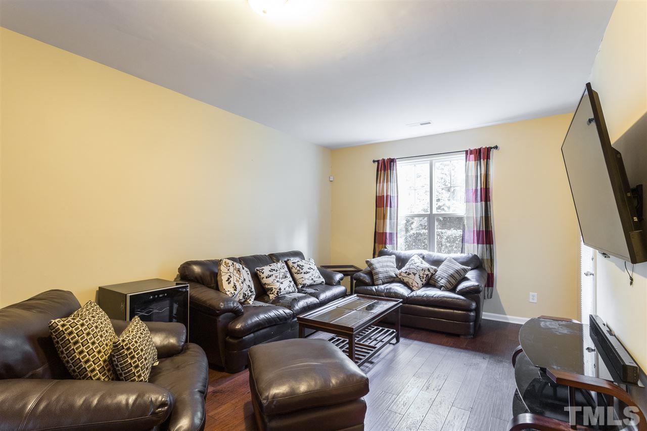 5004 Celtic Court Raleigh, NC 27612 - Photo 17 of 26 a living room with furniture and a flat screen tv