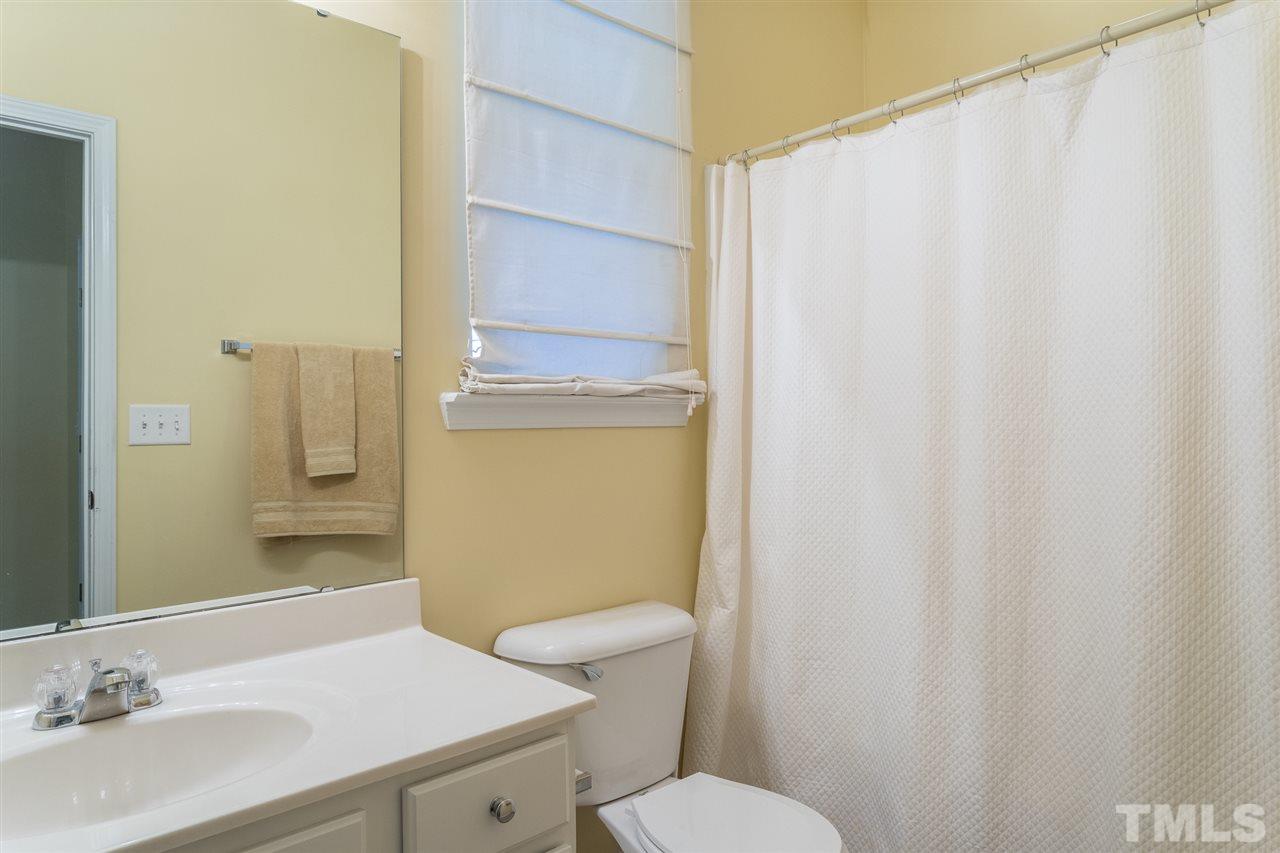5004 Celtic Court Raleigh, NC 27612 - Photo 19 of 26 a bathroom with a sink a toilet and shower curtain