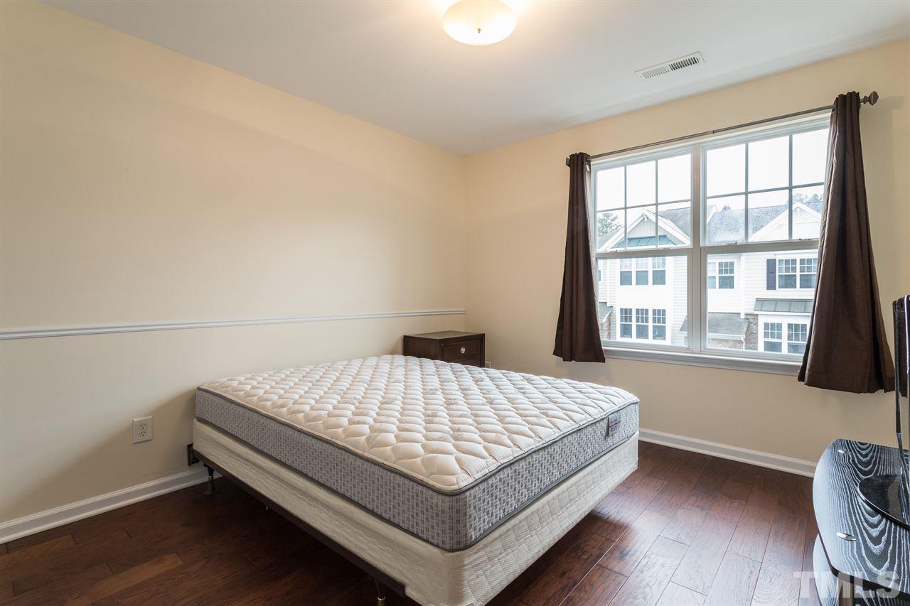 5004 Celtic Court Raleigh, NC 27612 - Photo 20 of 26 a bed sitting in a bedroom next to a window