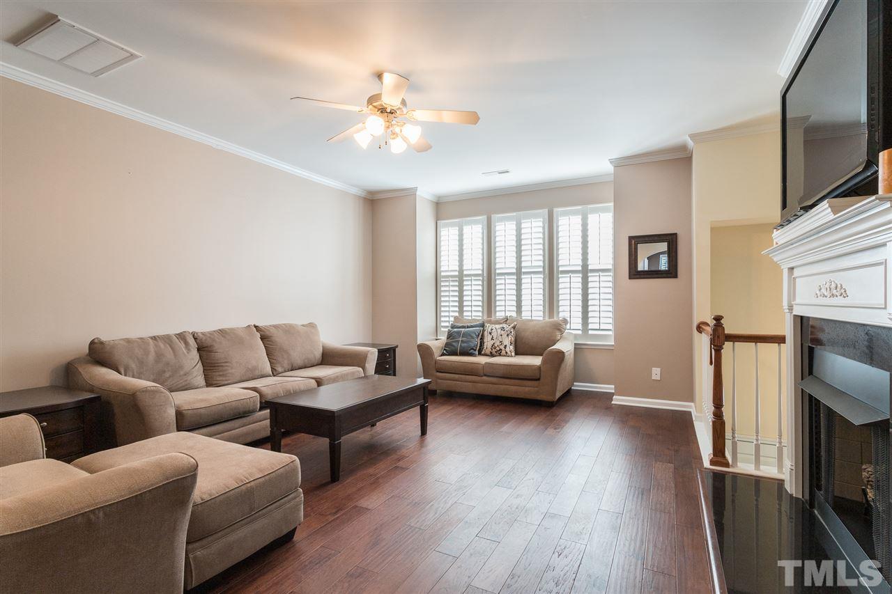 5004 Celtic Court Raleigh, NC 27612 - Photo 4 of 26 a living room with furniture and a flat screen tv