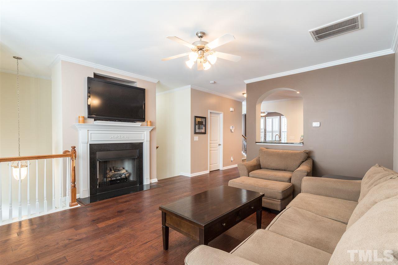 5004 Celtic Court Raleigh, NC 27612 - Photo 5 of 26 a living room with furniture a fireplace and a flat screen tv