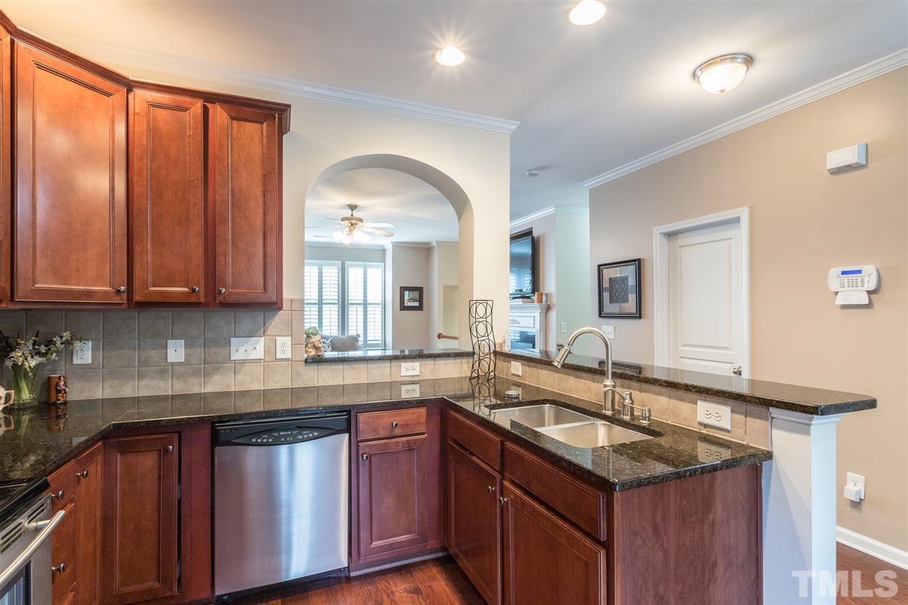 5004 Celtic Court Raleigh, NC 27612 - Photo 10 of 26 a kitchen with stainless steel appliances granite countertop a sink a stove cabinets and wooden floor