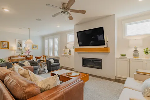 a living room with furniture a fireplace and a flat screen tv