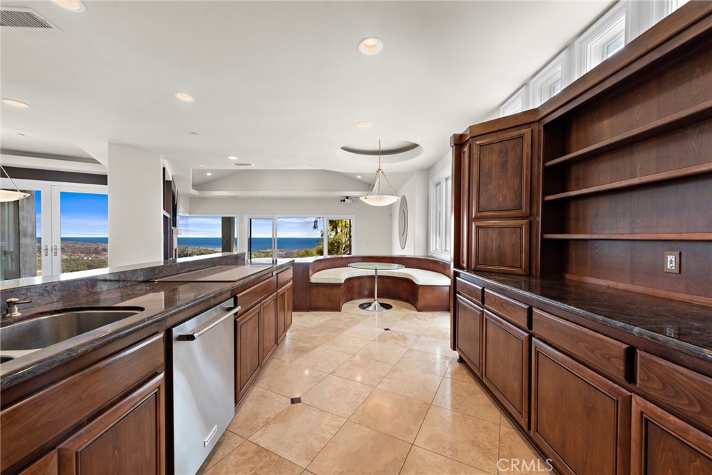 14 Mar Del Rey San Clemente, CA 92673 - Photo 18 of 70 a kitchen with stainless steel appliances granite countertop a sink and cabinets