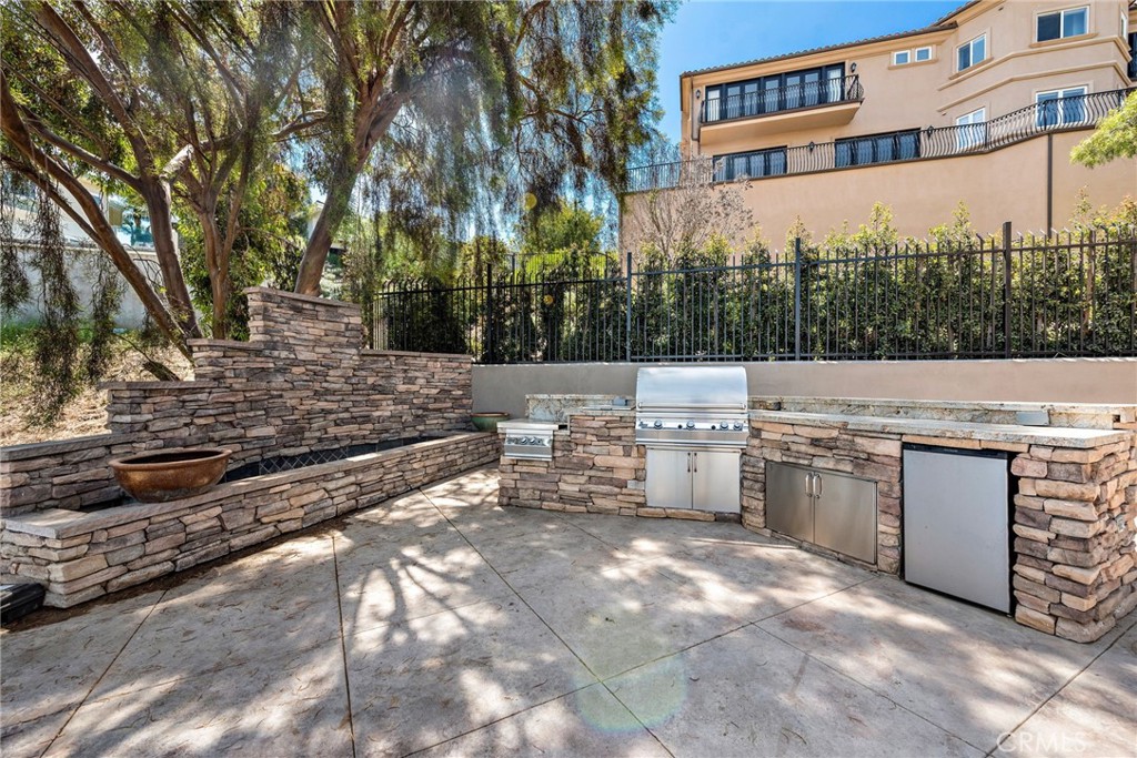 14 Mar Del Rey San Clemente, CA 92673 - Photo 29 of 70 a view of a patio with table and chairs and a barbeque