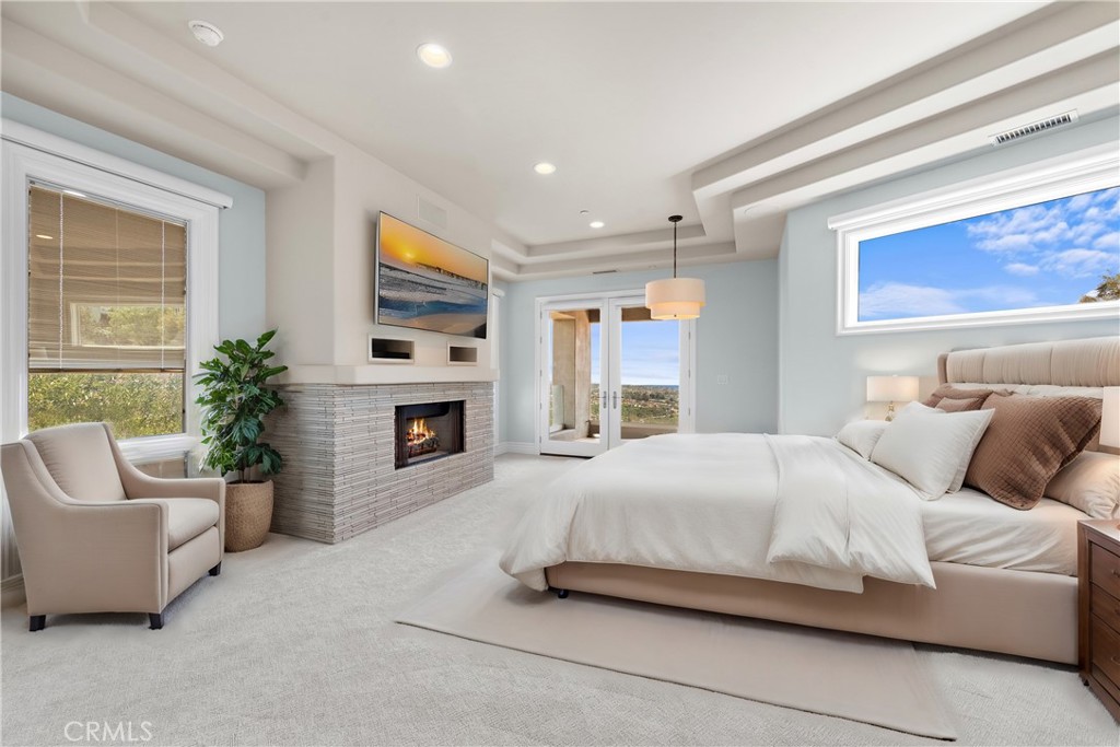 14 Mar Del Rey San Clemente, CA 92673 - Photo 38 of 70 a bedroom with a bed a couch and a fireplace