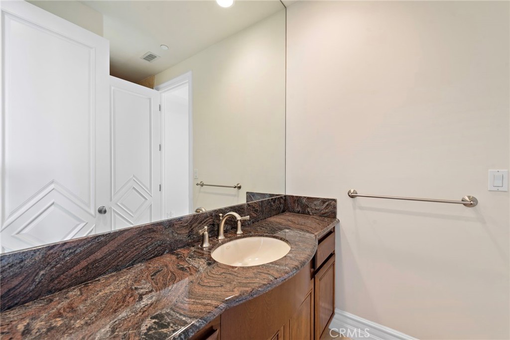 14 Mar Del Rey San Clemente, CA 92673 - Photo 50 of 70 a bathroom with a granite countertop sink and a mirror