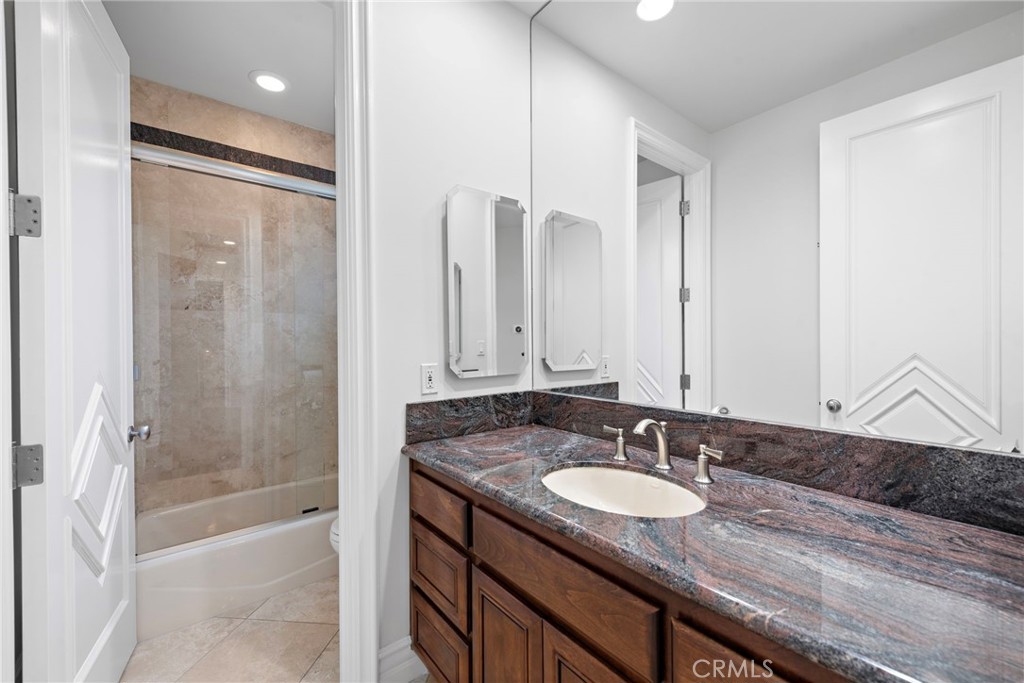 14 Mar Del Rey San Clemente, CA 92673 - Photo 58 of 70 a bathroom with a granite countertop sink a mirror and a shower