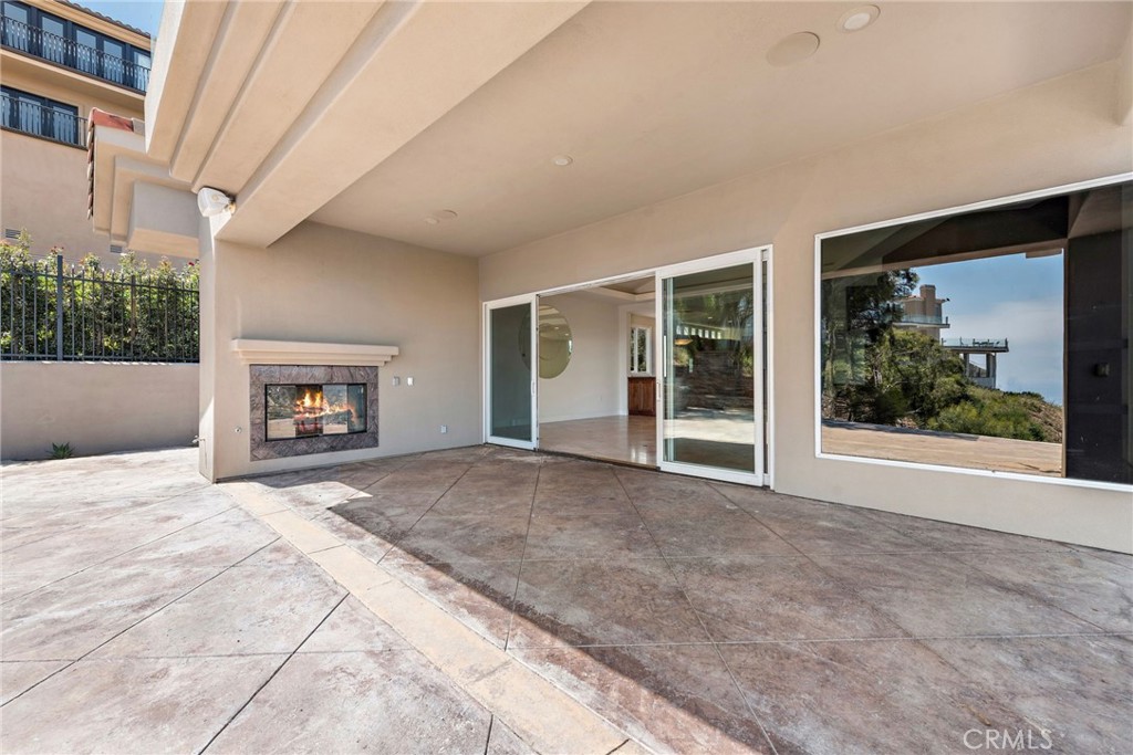 14 Mar Del Rey San Clemente, CA 92673 - Photo 10 of 70 a view of an empty room with a fireplace and a window
