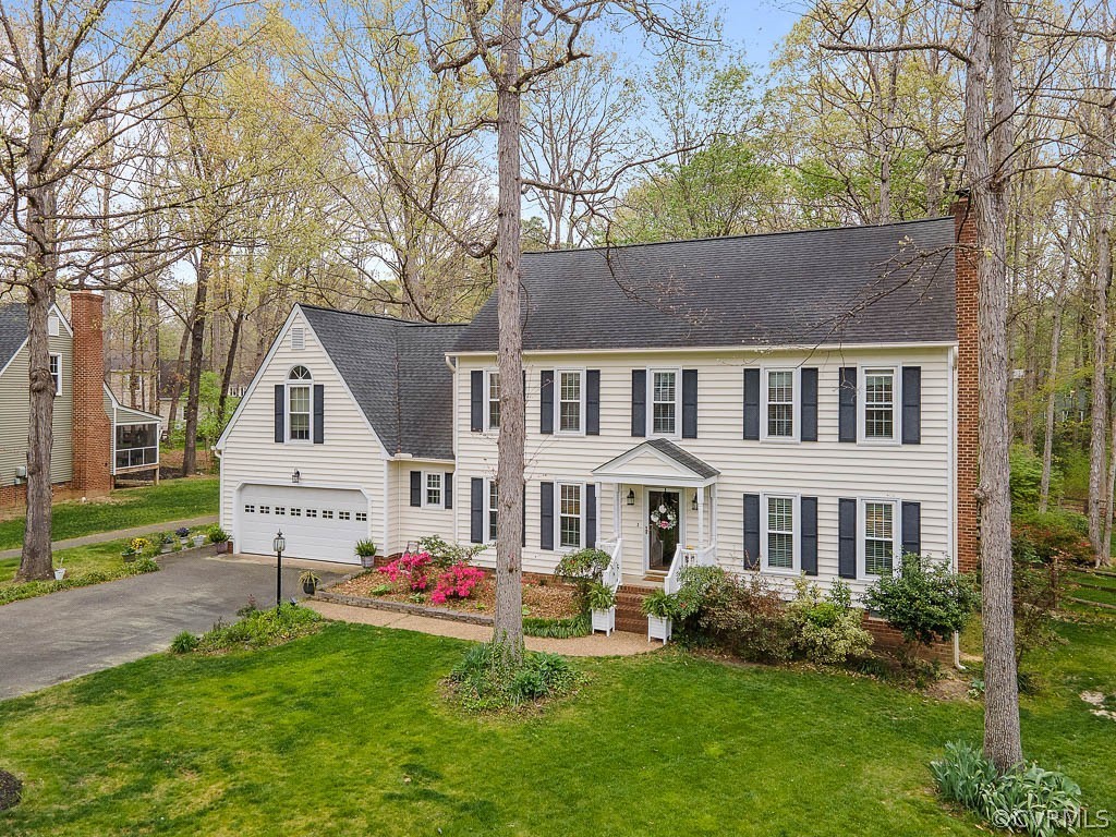 13813 Shadow Ridge Road Midlothian, VA 23112 - Photo 2 of 49 a front view of a house with a yard and garage