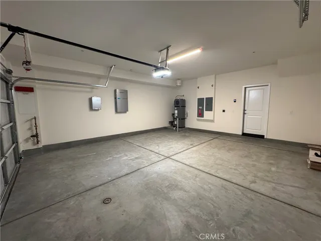 a large kitchen with a wooden floor and stainless steel appliances