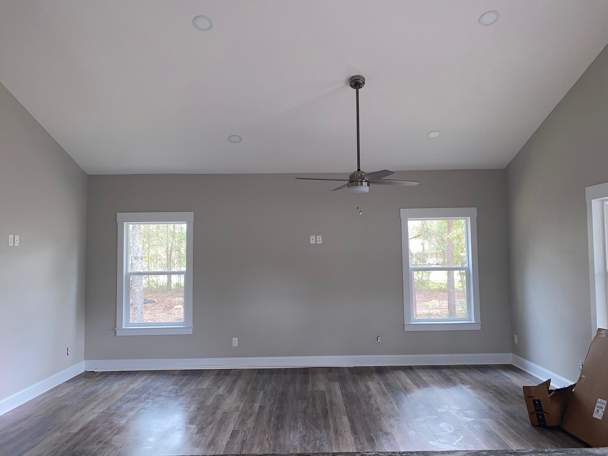 575 East Roberts Road DeFuniak Springs, FL 32433 - Photo 6 of 7 a view of an empty room with wooden floor and a window
