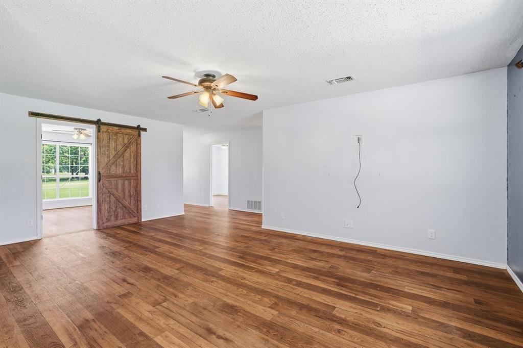1974 County Road Powderly, TX 75473 - Photo 11 of 28 a view of an empty room with wooden floor and a window