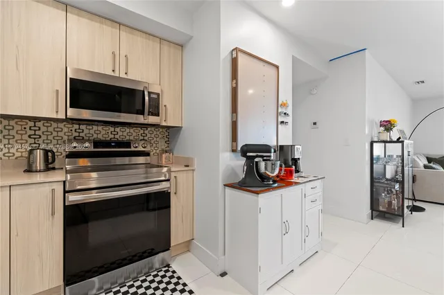 a kitchen with stainless steel appliances granite countertop a refrigerator and a stove