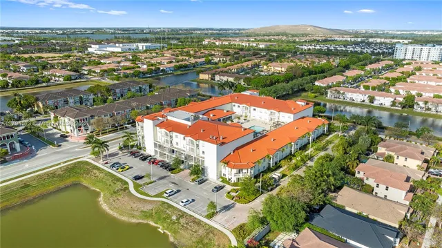 an aerial view of residential houses with outdoor space and parking