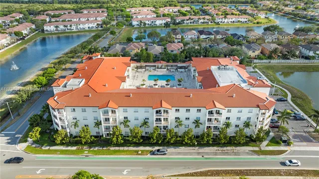 an aerial view of residential houses with yard