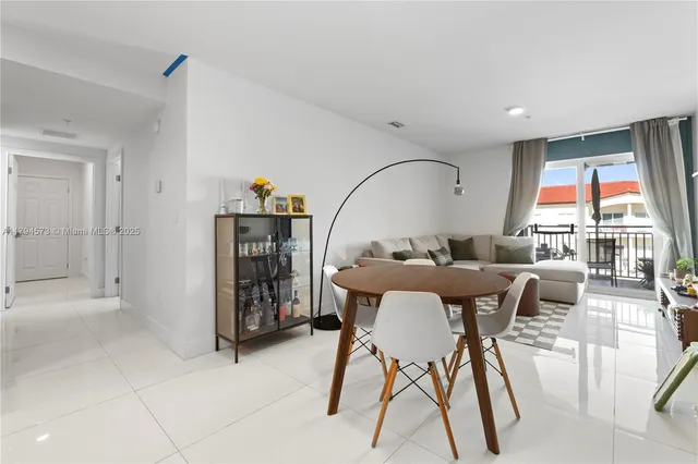 a living room with furniture potted plant and a window