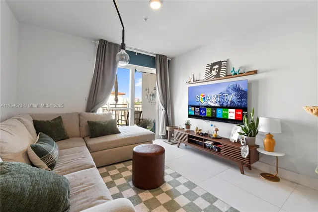a living room with furniture and a floor to ceiling window