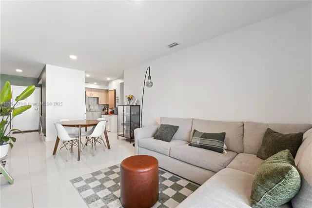 a view of a balcony with chairs and a potted plant