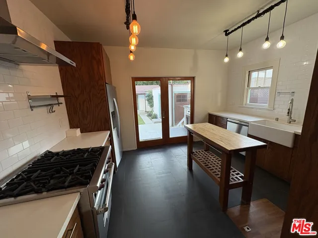 a kitchen with a sink a counter space and a stove