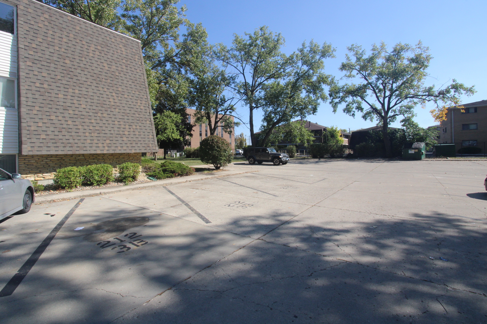 212 Madison Street, Unit 1B Joliet, IL 60435 - Photo 21 of 21 a backyard of a house with trees and flowers