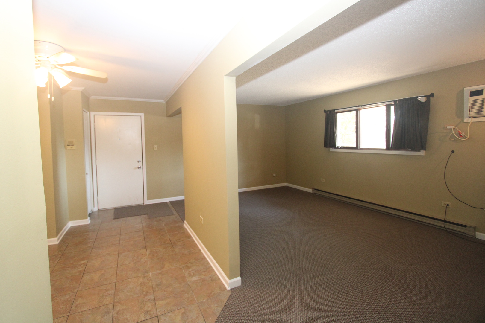 212 Madison Street, Unit 1B Joliet, IL 60435 - Photo 3 of 21 an empty room with windows