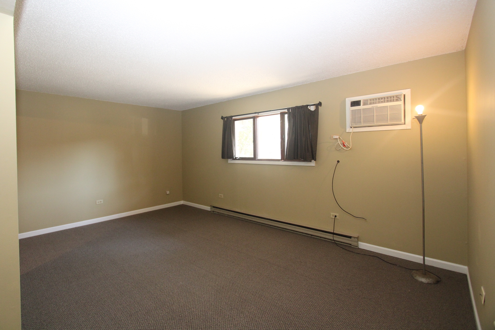 212 Madison Street, Unit 1B Joliet, IL 60435 - Photo 4 of 21 an empty room with windows