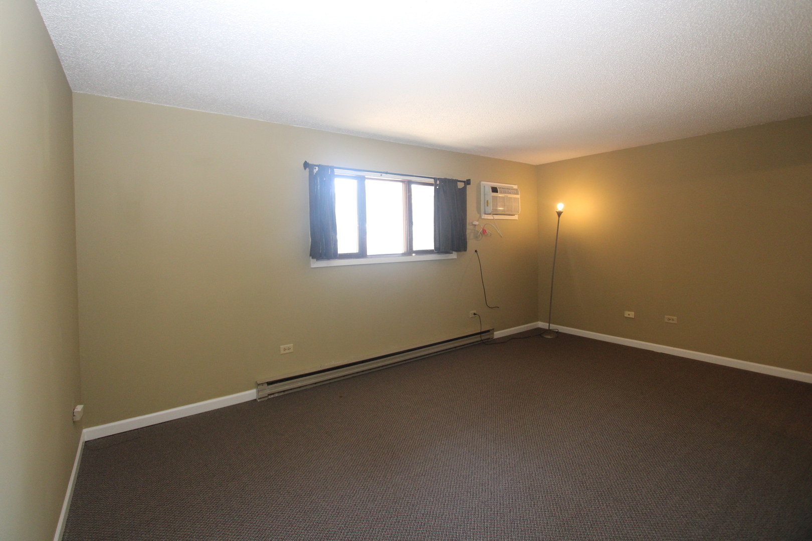 212 Madison Street, Unit 1B Joliet, IL 60435 - Photo 5 of 21 an empty room with a empty space and window