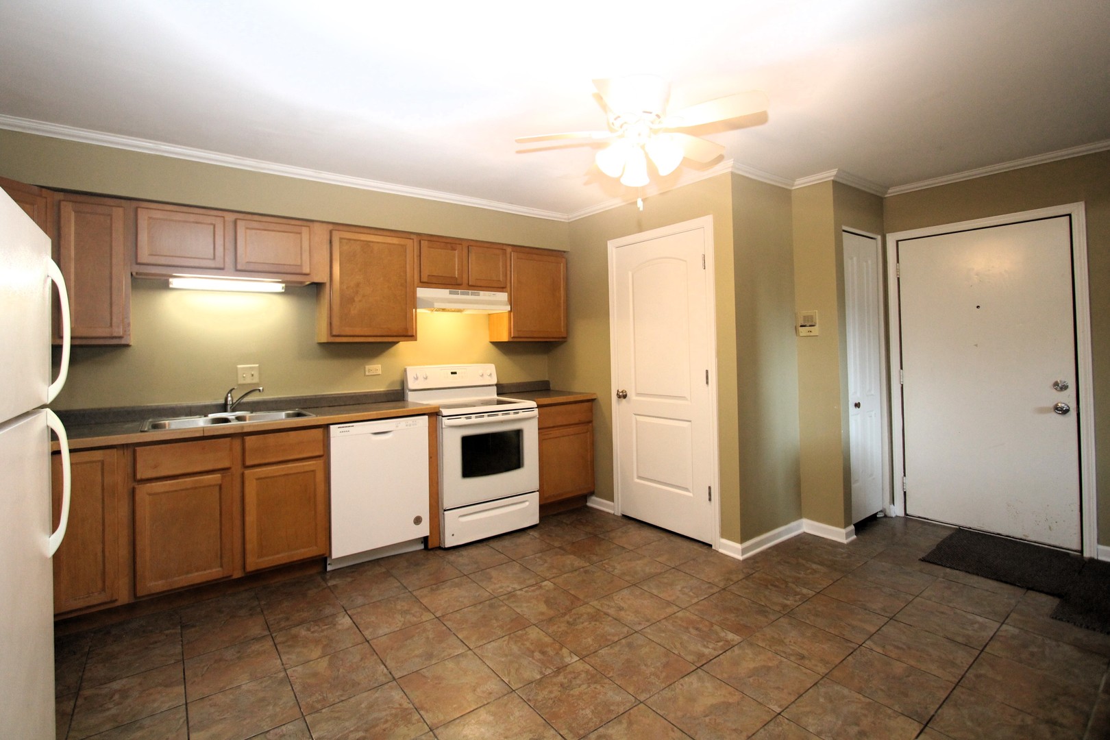 212 Madison Street, Unit 1B Joliet, IL 60435 - Photo 6 of 21 a kitchen with granite countertop a sink cabinets and stainless steel appliances