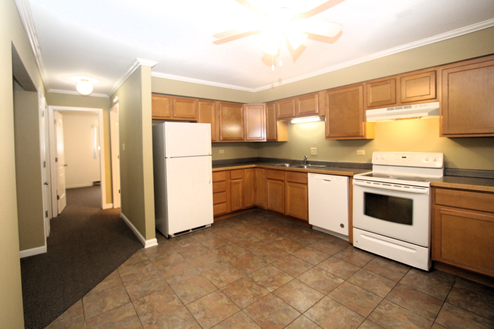 212 Madison Street, Unit 1B Joliet, IL 60435 - Photo 7 of 21 a kitchen with white cabinets and white appliances